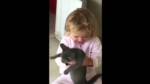 A sensible cat plays with a little girl