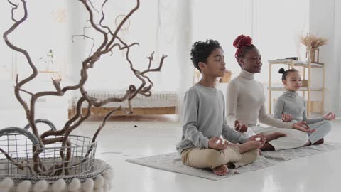 A Family Meditating Indoors