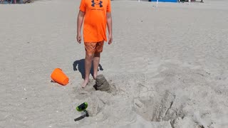 Spencer building a sand castle at the beach VID_20230730_150745
