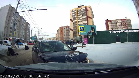 Pedestrians Walk in Front of Oncoming Car on Icy Road