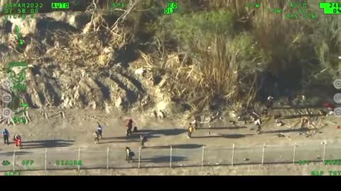 Helicopter footage shows a huge group of illegal immigrants using a rope to cross the Rio Grande