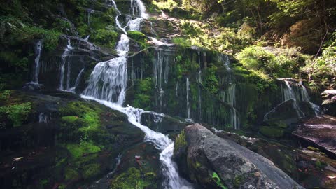 waterfall / The fall of river water from a high place onto solid and soft rocks such as erosion