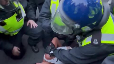 Watch as the met police throw a woman to the floor outside Downing Street.