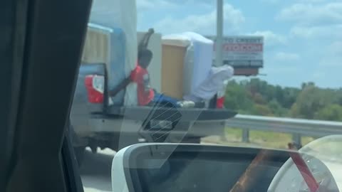 Hanging on in the Back of a Pickup Truck