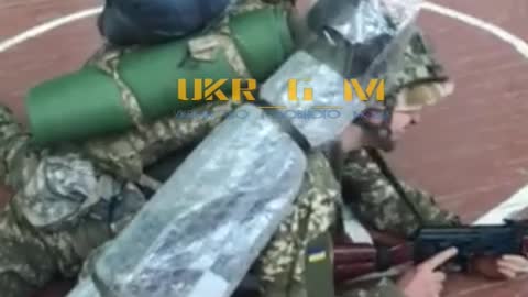 Ukraine military with weapons inside school gym