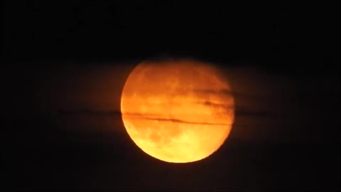 Full Moon Rising Into Clouds