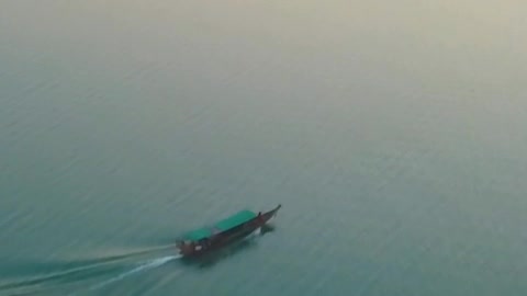 Motorboat on a large lake with turquoise blue waters