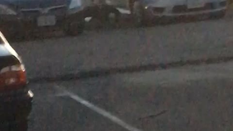 Guy does pushups between cars before going out to surf