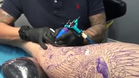 Girl getting leg sleeve tattoo