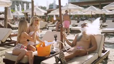 Tate smoking shisha at Romanian beach with girls