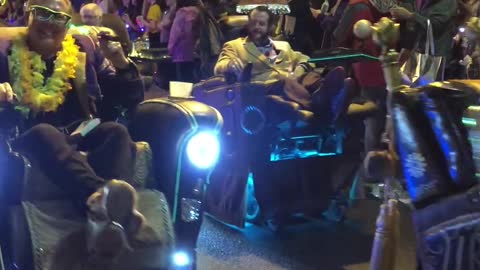 Men Rolling in Recliners During Mardi Gras