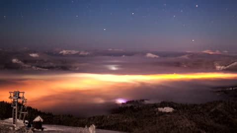 Landscape with illuminated clouds at night