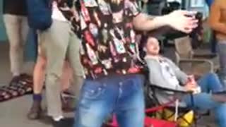 Guy wearing shirts with bottles flips guitar hits friend