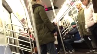 Four passengers stand still on subway train eyes closed