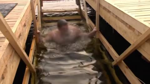 Russians dive into ice-cold water to celebrate Epiphany