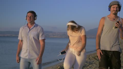 Friends dancing together at the beach