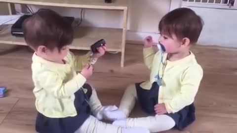 Twin baby girls fighting for car keys