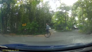 Dashcam Captures Unicyclist Peddling Down the Road