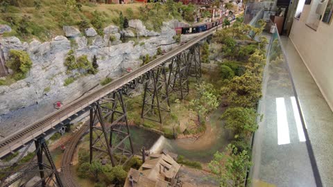 Gordon Pulling The Express And A Clinchfield Challenger Crossing An HO Scale High Bridge