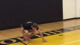 Guy goes for dunk off of chair and falls on back basketball court