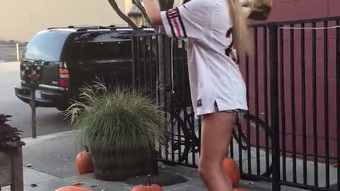 Girl tries to smash pumpkins but ends up falling