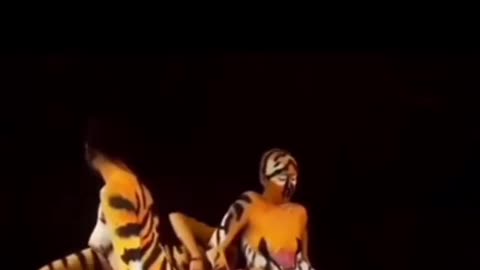 4 girls camouflage themselves in a tiger