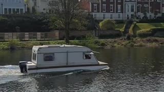 A Cool Caravan Boat Floating the River