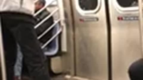 Man plays ping pong two paddles on subway