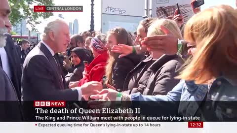 The King greets people currently queuing to see Queen Elizabeth II's coffin