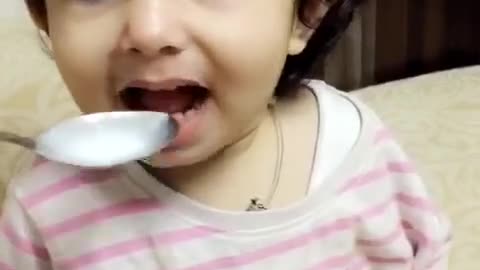 Baby girl wrinkles her nose at the food but wants more!