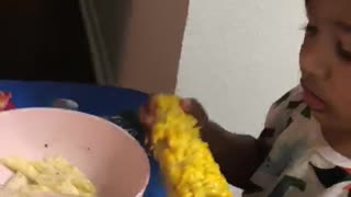 BABY EATING CORN ON THE COBB