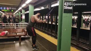 Pt. 1 guy works out in subway station using suspension ropes