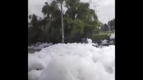 Polluted river near Colombia's capital blows toxic foam into residential areas