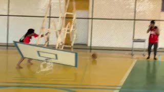 Friend Helps Complete a Dunk Breaking Basket