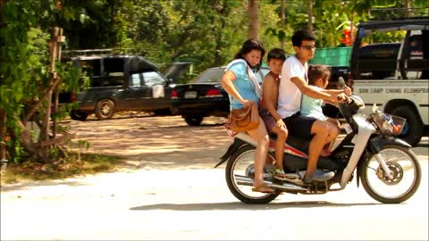 Entire family rides on a scooter