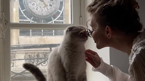 A Woman Kissing her Cat