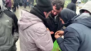 Migrants queue for food by Belarus-Poland border