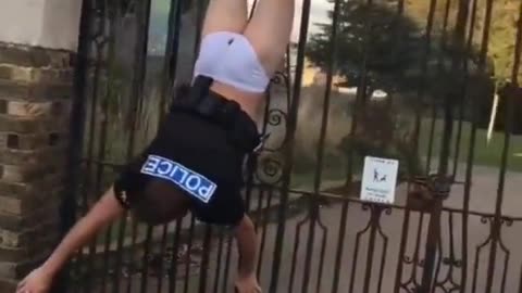 Cop gets stuck on a fence