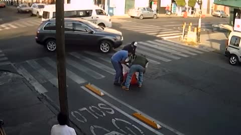 Different Pedestrians Trip Over Same Bumper While Crossing Road