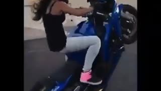 Girl doing stunts on a motorcycle