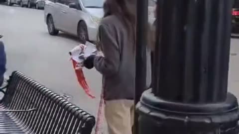 A young man from USA destroys posters of Israeli children kidnapped by Hamas.