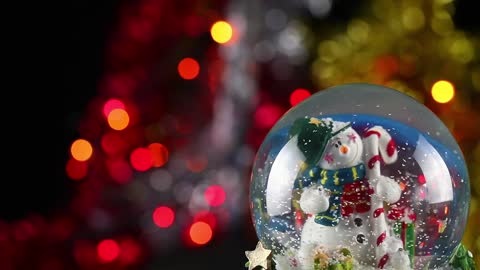 Christmas glass ball with defocused lights behind