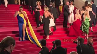 Woman dressed in Ukrainian colours stages protest on Cannes red carpet, pours fake blood on herself