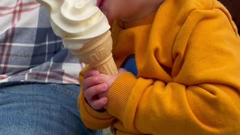 cute baby eating ice cream for the first time