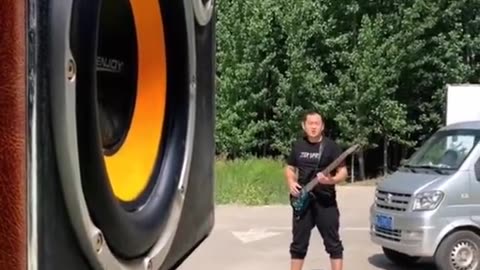 Playing Guitar In front Of A Huge Speaker