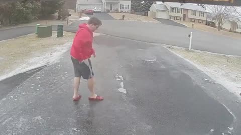 Guy Slips And Falls On His Butt While Walking On Icy Road