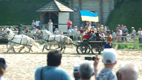 Kopachiv, Ukraine. People riding a horse with the flag. Historical and cultural park Kievan Rus