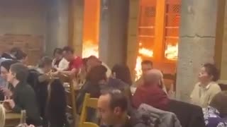 France: Parisians eating while Paris burns.. bizarre!