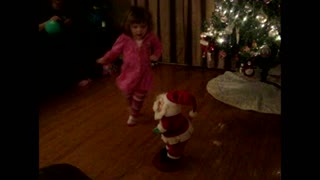 Young girl and santa shake their groove thing on the dance floor