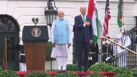 Biden lowers his hand from his heart after realizing they're playing the Indian national anthem